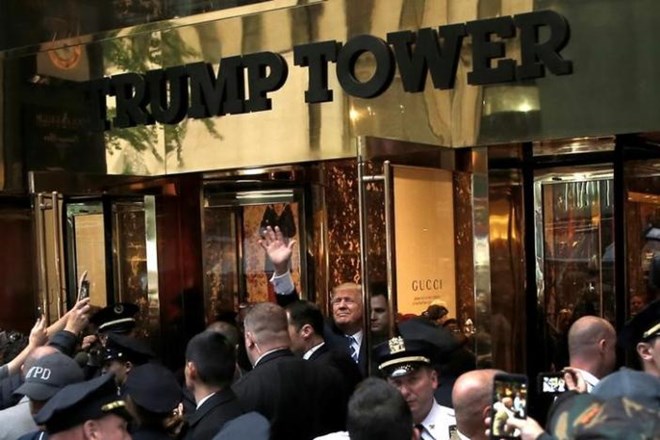 Republican presidential nominee Donald Trump waves to supporters outside the front door of Trump Tower where he lives in the Manhattan borough of New York, U.S., October 8, 2016. REUTERS/Mike Segar